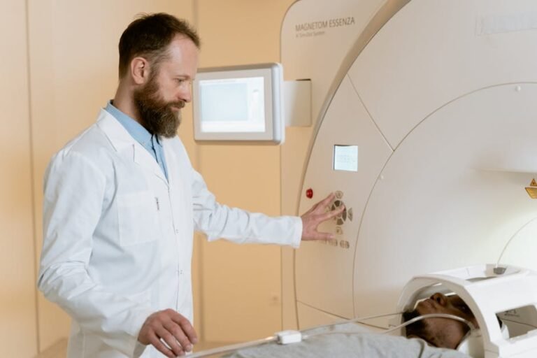 A doctor operates an MRI machine as a patient undergoes a scan in a medical facility.