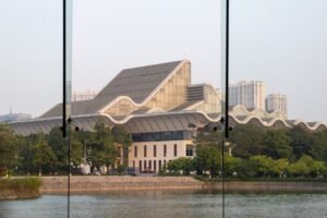 Contemporary architecture building by a river in Hanoi, Vietnam, captured in daylight.