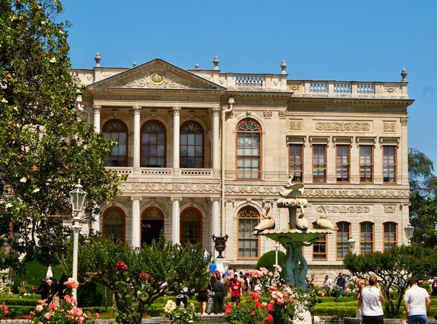 Elegant Ottoman architecture of a grand palace in Istanbul surrounded by vibrant gardens.