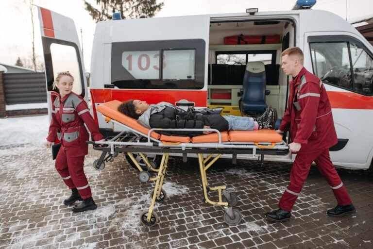 Paramedics transport a patient on a stretcher to an ambulance, showcasing emergency medical response.