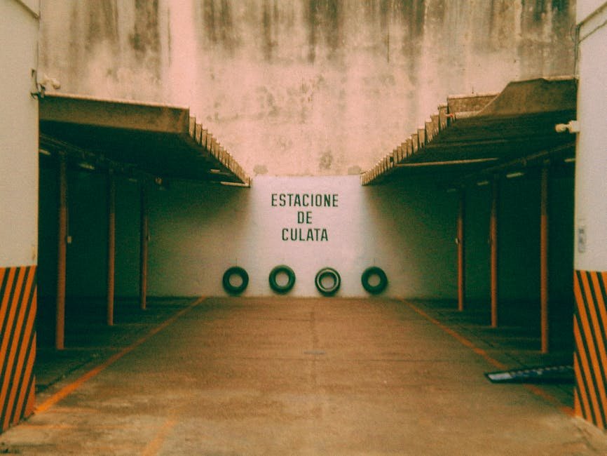 Empty parking area with Spanish signage and worn industrial texture in Rosario, Argentina.