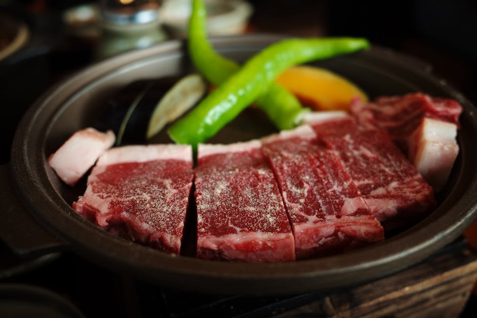 Close-up of marbled Wagyu beef with green peppers in Kyoto, Japan.