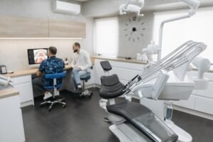 Dental professionals discussing patient images in a modern clinic setting.
